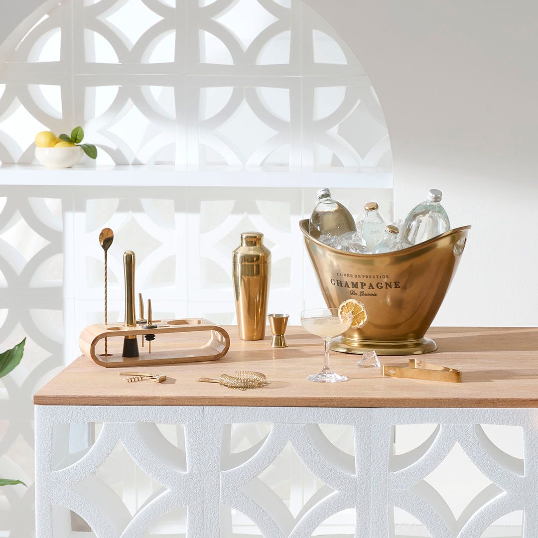 https://s3-ap-southeast-2.amazonaws.com/fusionfactory.commerceconnect.bbnt.production/pim_media/000/174/087/M_F_Summer_S24-25_LS_Studio_Barware-Champagne_Bucket_Flared_Brass-Cocktail_Bar_Tool_Set-9pc_Gold.jpg?1729746523